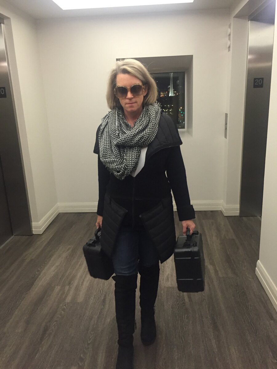 Carrie carrying two cases with humidors filled with custom-blended cigars.