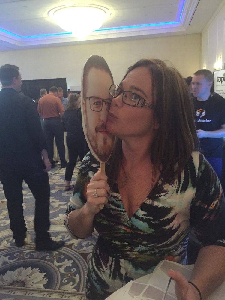 Kissing a giant cardboard face on a stick