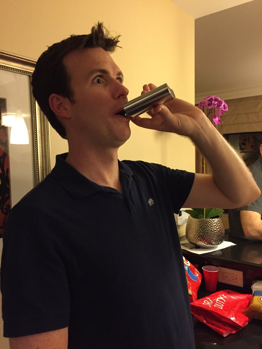 A friend wide-eyed mid-sip from a flask