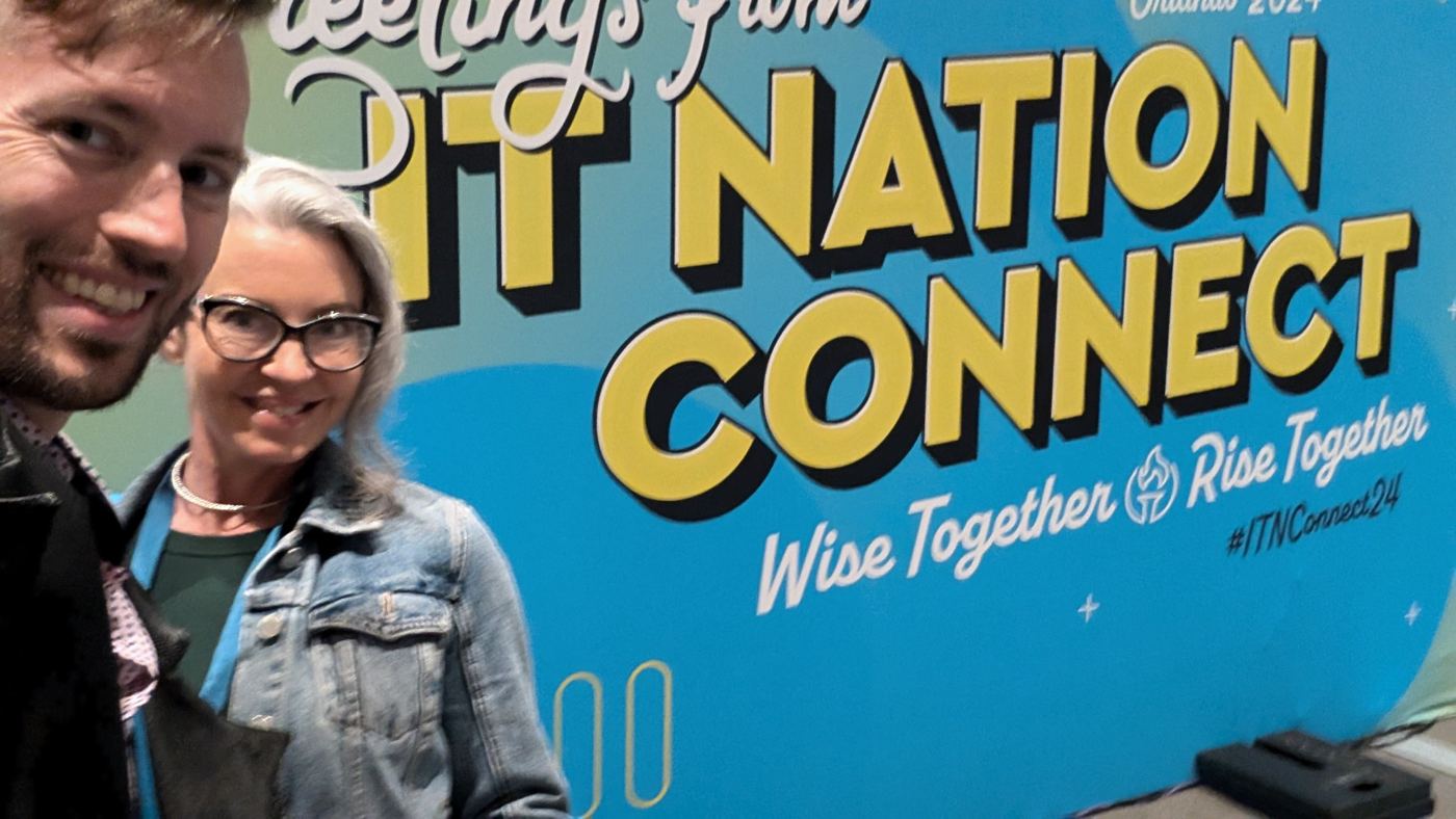 Ian and Carrie taking a selfie in front of the show sign