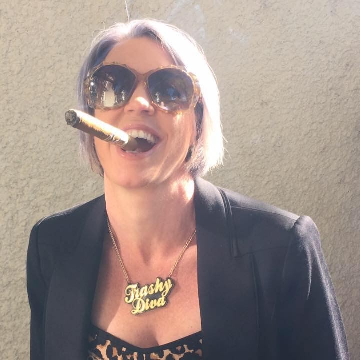 Cigar in mouth, big sunglasses, and a Trashy Diva necklace